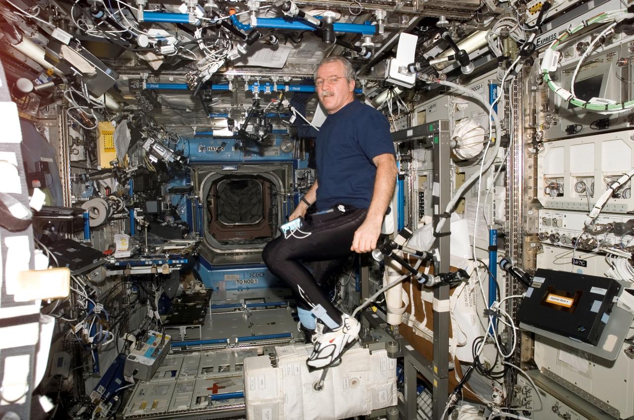 ISS011-E-13111 (16 September 2005) --- Astronaut John L. Phillips, Expedition 11 NASA science officer and flight engineer, exercises on the Cycle Ergometer with Vibration Isolation System (CEVIS) in the Destiny laboratory of the international space station.