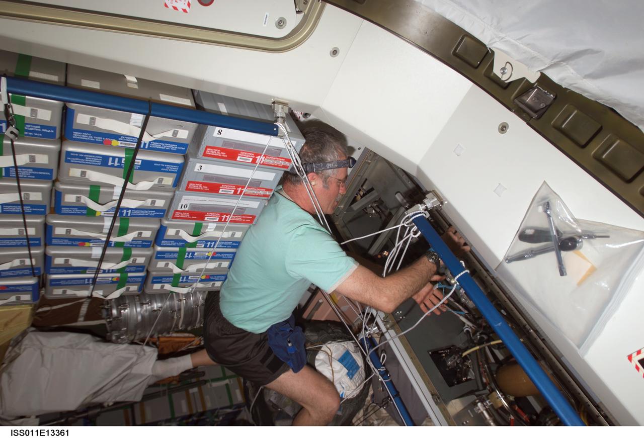 ISS011-E-13361 (20 September 2005) --- Astronaut John L. Phillips, Expedition 11 NASA science officer and flight engineer, performs a Remote Power Control Module (RPCM) remove and replacement in the Unity node of the international space station.