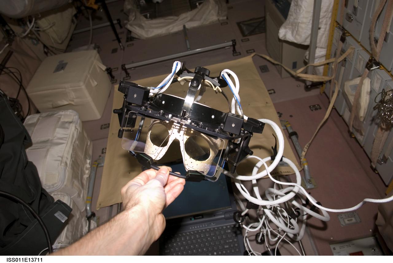 ISS011-E-13711 (25 September 2005) --- The European Space Agency (ESA) Eye Tracking Device (ETD) payload held by an Expedition 11 crewmember in the Zvezda Service Module of the international space station.