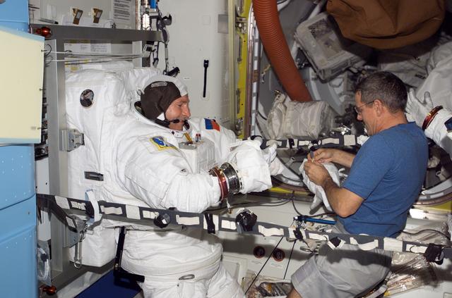 NASA image: Tokarev and McArthur conduct an EMU don/doff practice during Expedition 12