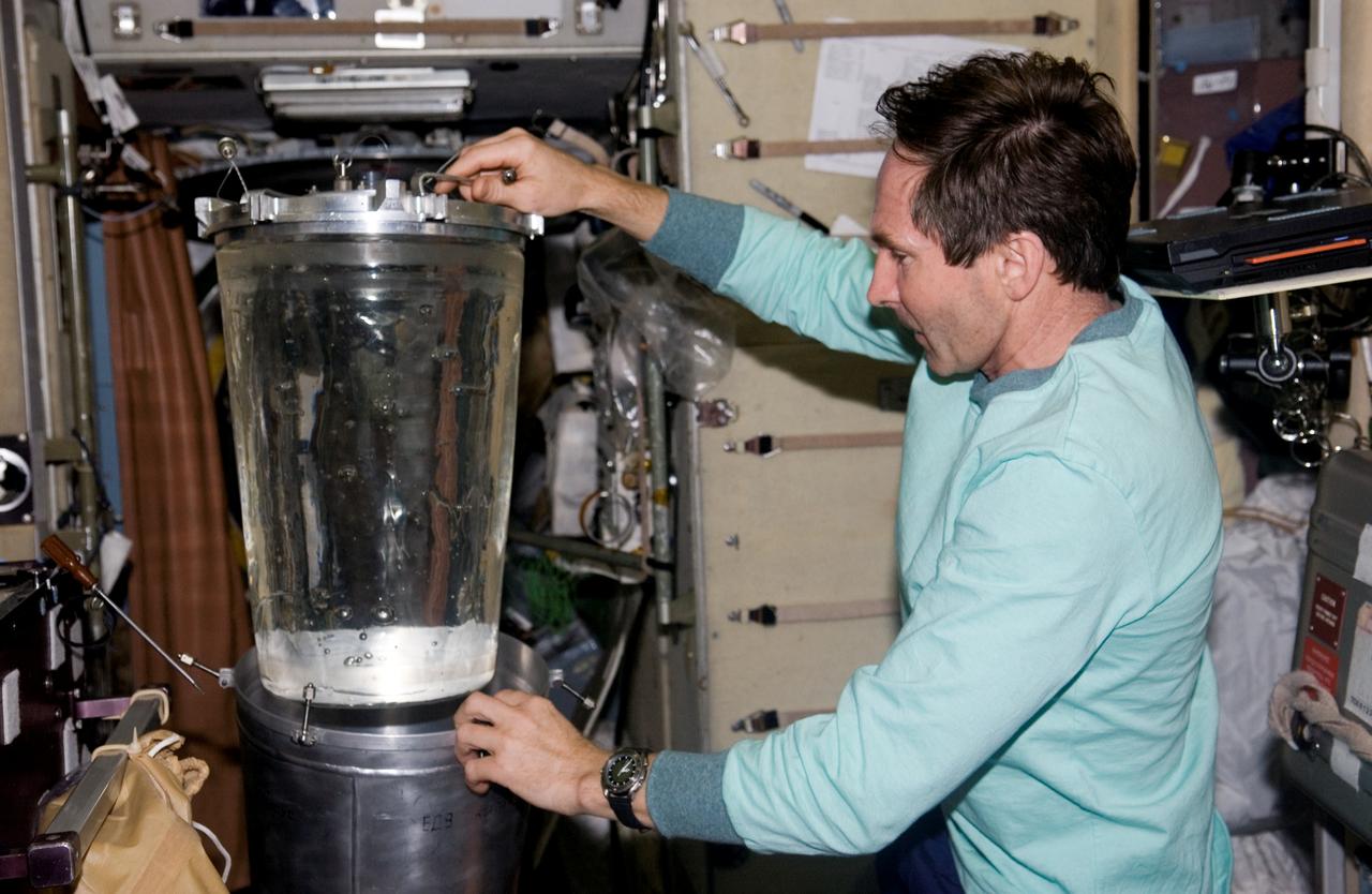 ISS012-E-06290 (3 November 2005) --- Cosmonaut Valery I. Tokarev, Expedition 12 flight engineer representing Russia's Federal Space Agency, performs a water transfer from Progress Tanks 1 and 2 to the Russian EDV water container in the Zvezda Service Module of the International Space Station.