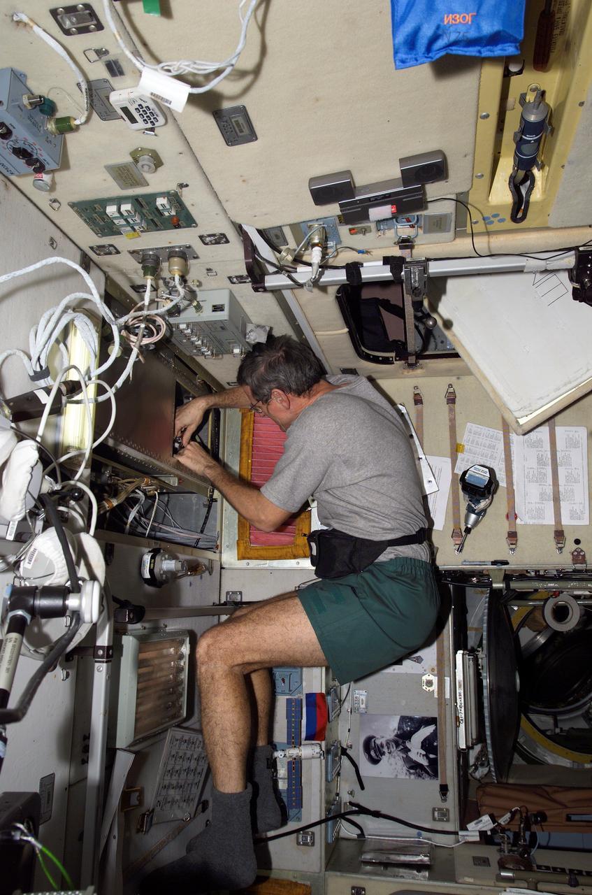 ISS012-E-09763 (30 Nov. 2005) --- Astronaut William S. (Bill) McArthur Jr., Expedition 12 commander and NASA space station science officer, performs preventive maintenance and cleaning of the Russian segment SOTR ventilation systems in the Zvezda Service Module of the international space station.