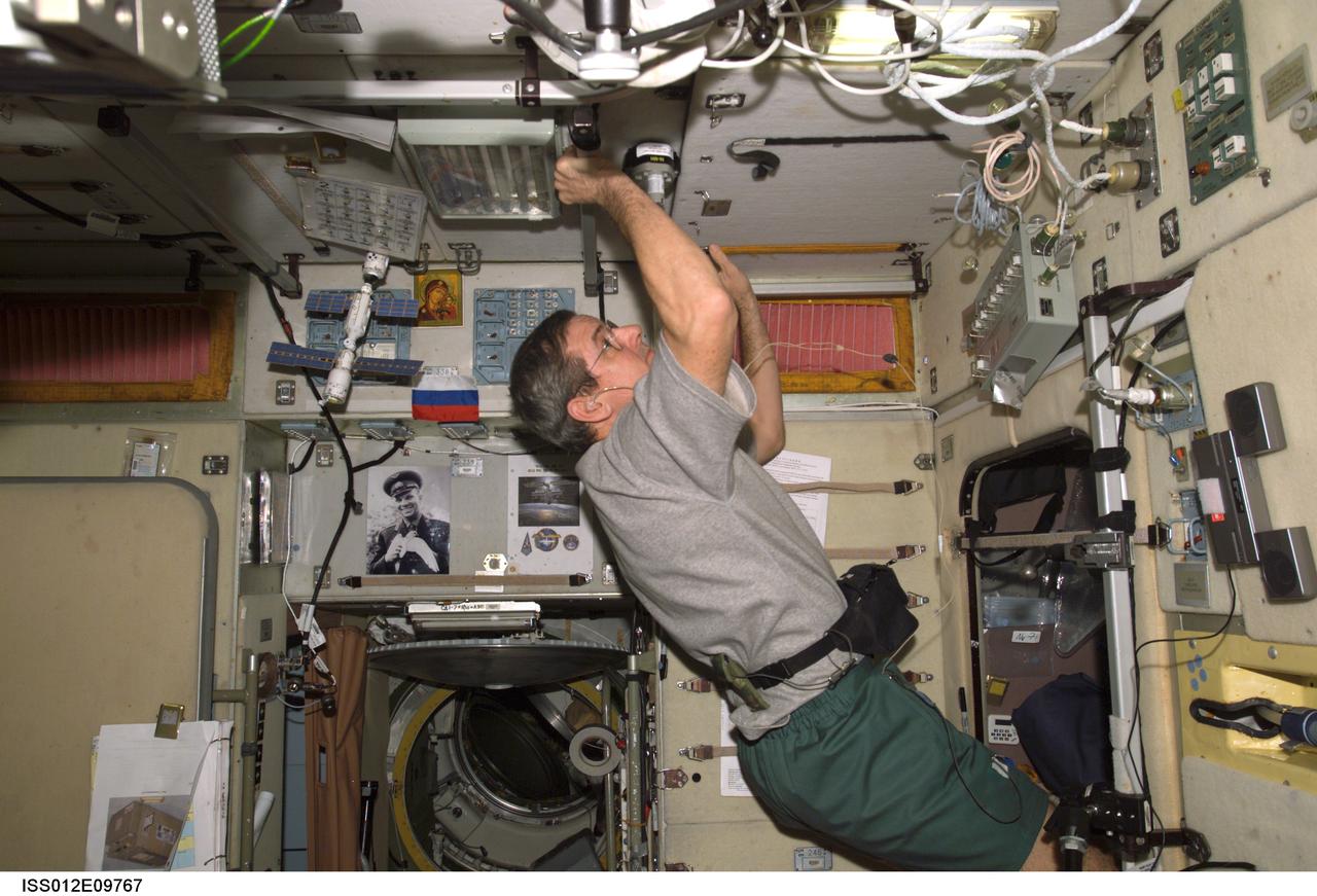 ISS012-E-09767 (30 November 2005) --- Astronaut William S. (Bill) McArthur Jr., Expedition 12 commander and NASA space station science officer, performs preventive maintenance and cleaning of the Russian segment SOTR ventilation systems in the Zvezda Service Module of the international space station.