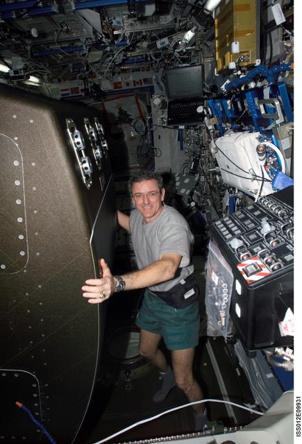 NASA image: McArthur rotates the CHeCS rack back into position after cleaning the AAA fan