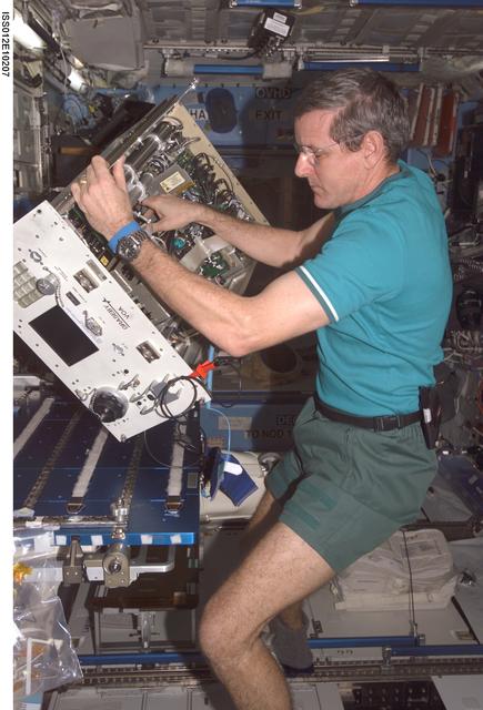 NASA image: McArthur prepares to replace the top panels on the VOA during In-flight Maintenance on Expedition 12