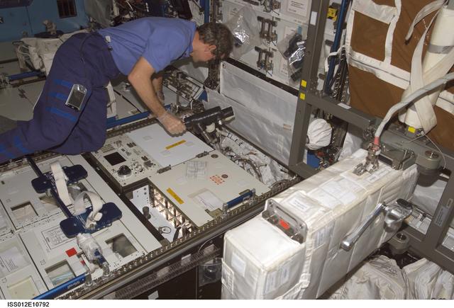NASA image: McArthur installs an ITCS coolant sampling tool onto the CHeCS Rack during Expedition 12