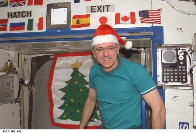 NASA image: McArthur wears a Santa hat to celebrate Christmas during Expedition 12