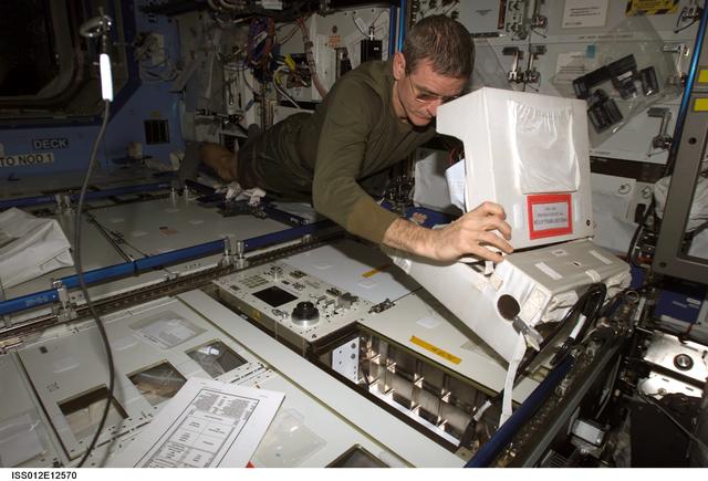 NASA image: McArthur completes a battery charge on the defibrillator during Expedition 12