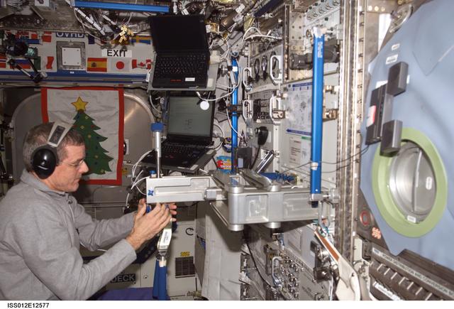 NASA image: McArthur sets up the SLAMMD hardware in the U.S. Lab during Expedition 12