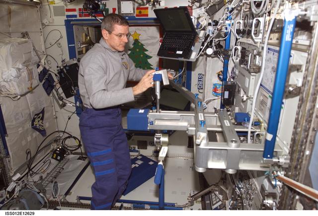 NASA image: McArthur sets up the SLAMMD hardware in the U.S. Lab during Expedition 12