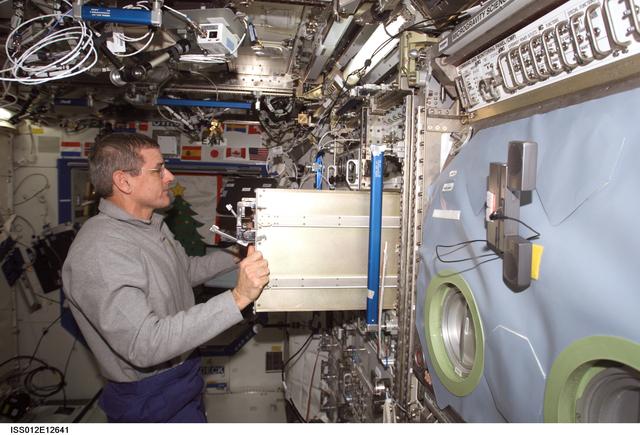 NASA image: McArthur stows SLAMMD hardware in the U.S. Lab during Expedition 12