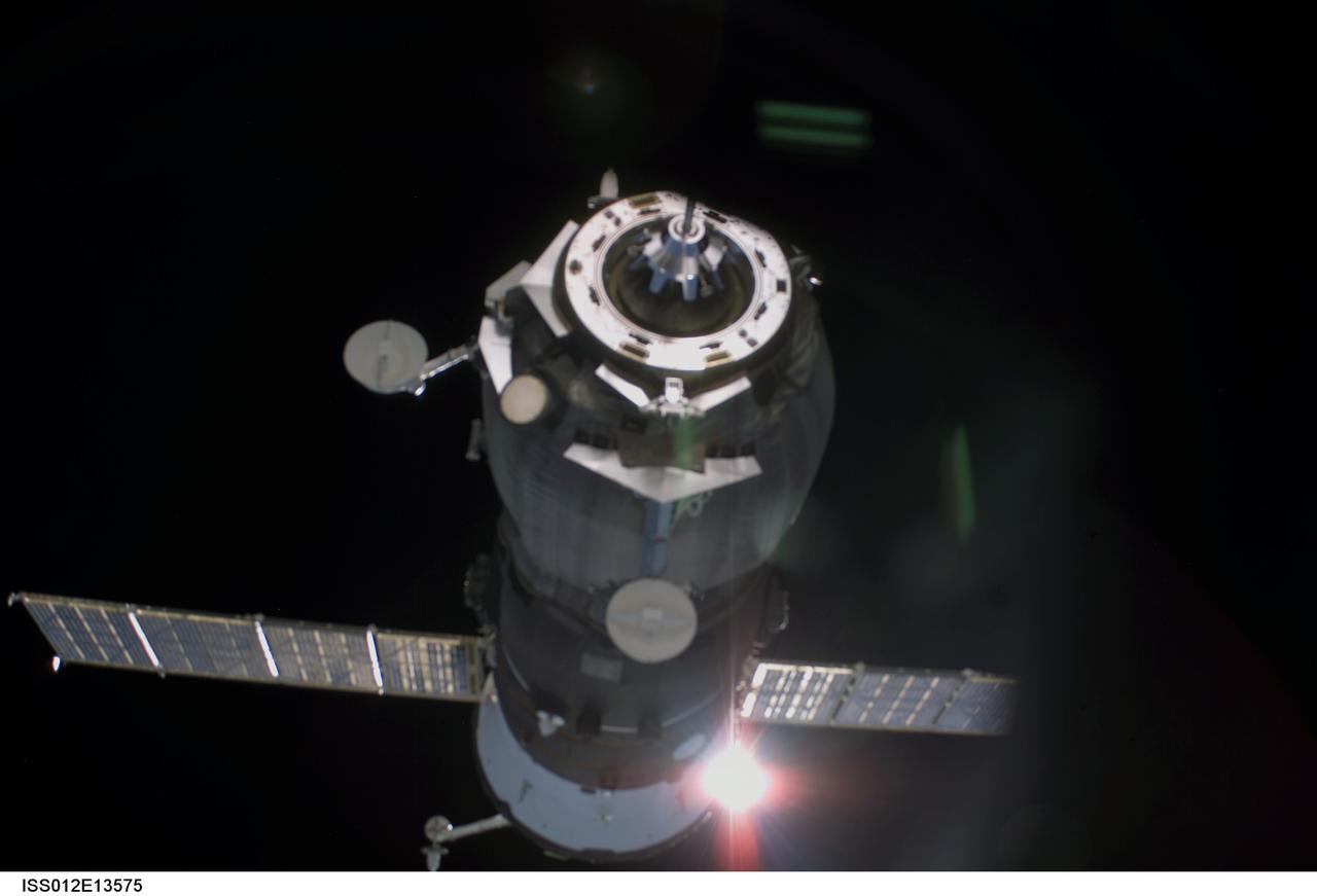 ISS012-E-13575 (23 Dec. 2005) --- Backdropped by the blackness of space, an unpiloted Progress supply vehicle approaches the International Space Station. The Progress 20 resupply craft launched at 12:38 p.m. (CST) on Dec. 21, 2005 from the Baikonur Cosmodrome in Kazakhstan to deliver 2.8 tons of supplies, gifts, food, water, fuel and equipment to the Expedition 12 crew members onboard the station. Progress docked to the Pirs Docking Compartment at 1:46 p.m. (CST) on Dec. 23 as the station flew approximately 220 statute miles above the Atlantic off the east coast of South America.
