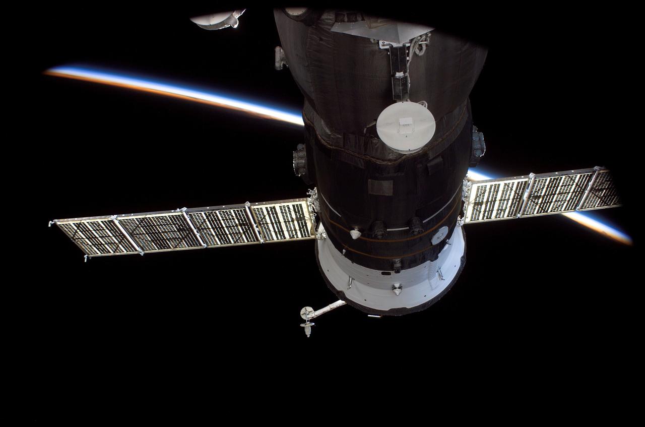 ISS012-E-13579 (23 Dec. 2005) --- The blackness of space and airglow of Earth’s horizon provide the backdrop for this scene of the Progress 20 resupply vehicle, docked to the Pirs Docking Compartment of the International Space Station. Progress 20 launched at 12:38 p.m. (CST) on Dec. 21, 2005 from the Baikonur Cosmodrome in Kazakhstan to deliver 2.8 tons of supplies, gifts, food, water, fuel and equipment to the Expedition 12 crew members onboard the station. Progress docked to the Pirs Docking Compartment at 1:46 p.m. (CST) on Dec. 23 as the station flew approximately 220 statute miles above the Atlantic off the east coast of South America.