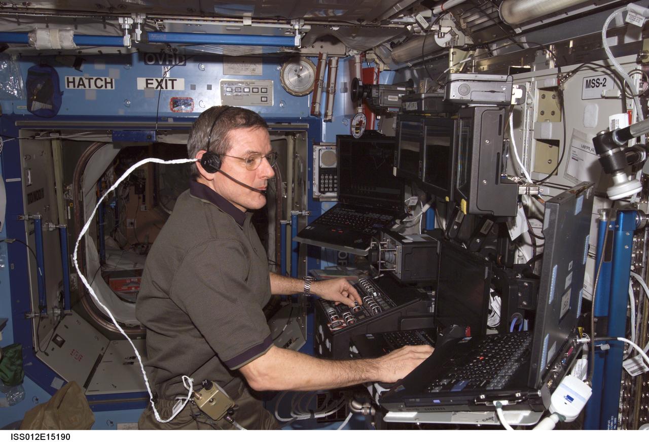 ISS012-E-15190 (13 Jan. 2006) --- Astronaut William S. (Bill) McArthur, Expedition 12 commander and NASA space station science officer, maneuvers the Space Station Remote Manipulator System (SSRMS) or Canadarm2 in the Destiny laboratory of the International Space Station during a survey of the Unity node Nadir Active Common Berthing Mechanism (ACBM) to look for possible debris or damage on the sealing surface.