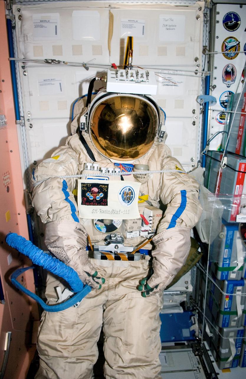 ISS012-E-15666 (24 Jan. 2006) --- An old Russian Orlan spacesuit is photographed in the Unity node of the International Space Station, which will be released by hand from the space station during a spacewalk Feb. 3, 2006. Outfitted with a special radio transmitter and other gear, the spacesuit comprises a Russian experiment called SuitSat. It will fly free from the station as a satellite in orbit for several weeks of scientific research and radio tracking, including communications by amateur radio operators. Eventually, it will enter the atmosphere and be destroyed.