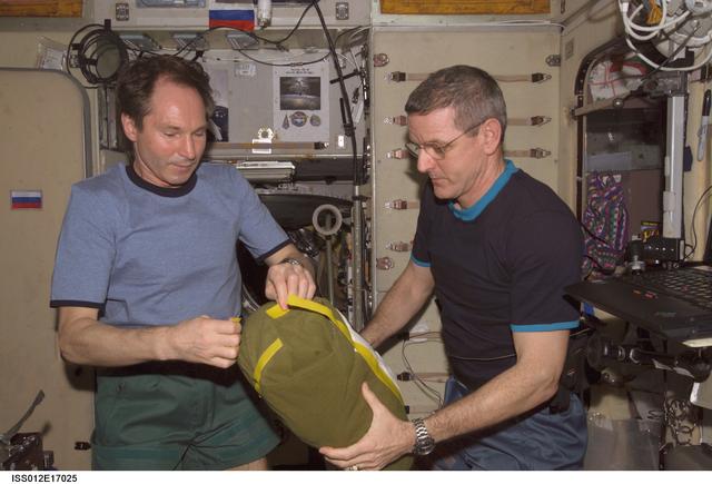 NASA image: Tokarev and McArthur open the SM-RadioSkaf-11.1 Kit on Expedition 12