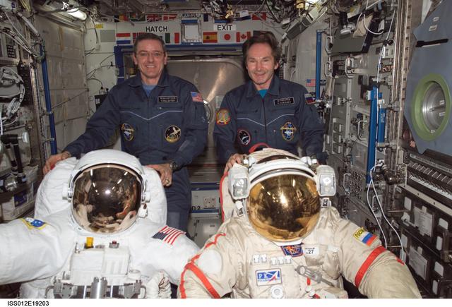 NASA image: McArthur and Tokarev pose with EMUs during Expedition 12