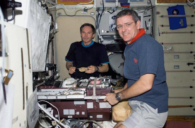NASA image: McArthur and Tokarev eat a meal at the galley during Expedition 12