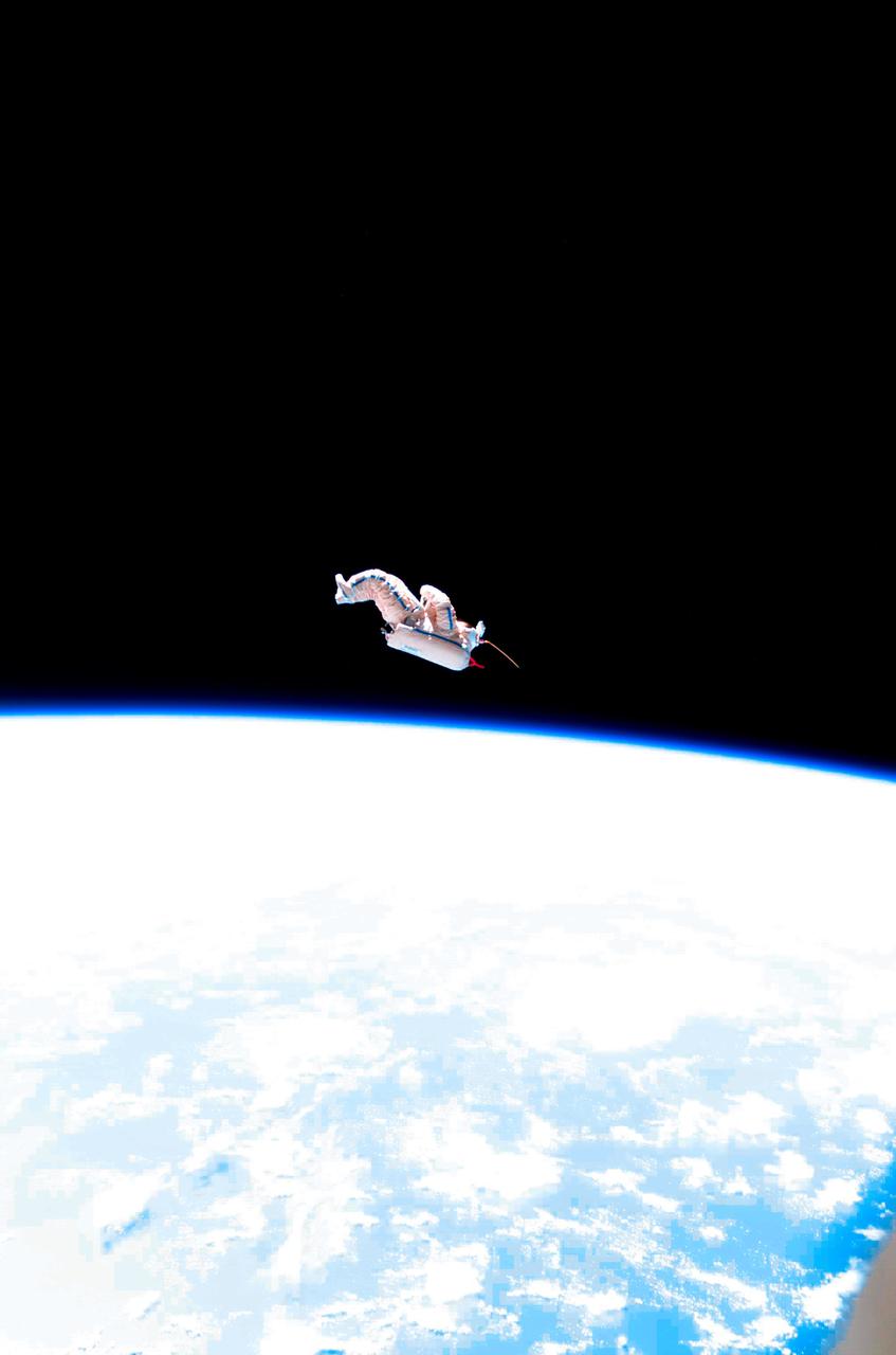 ISS012-E-24449 (3 Feb. 2006) --- Backdropped by the blackness of space and Earth's horizon, a spacesuit-turned-satellite called SuitSat began its orbit around the Earth after being released by the Expedition 12 crewmembers during a session of extravehicular activity (EVA) on Feb. 3, 2006. SuitSat, an unneeded Russian Orlan spacesuit, was outfitted by the crew with three batteries, internal sensors and a radio transmitter, which faintly transmitted recorded voices of school children to amateur radio operators worldwide. The suit will enter the atmosphere and burn up in a few weeks.