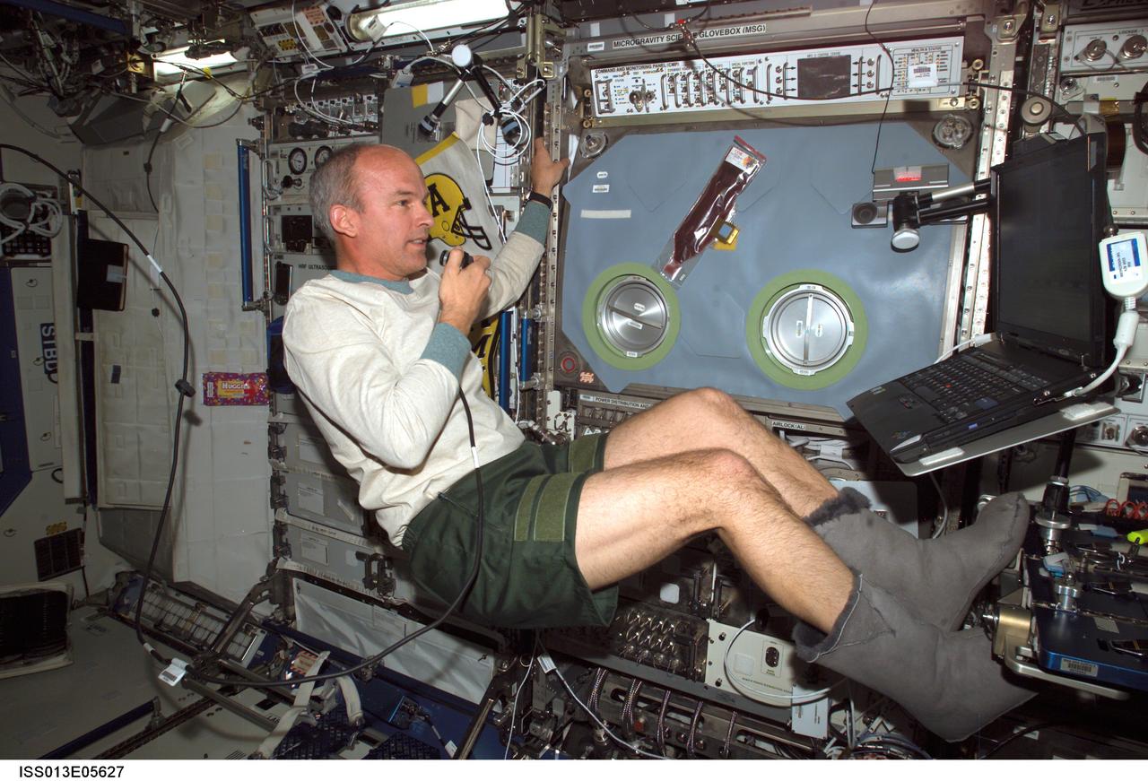 ISS013-E-05627 (9 April 2006) --- Astronaut Jeffrey N. Williams, Expedition 13 NASA space station science officer and flight engineer, uses a communication system in the Destiny laboratory of the International Space Station.