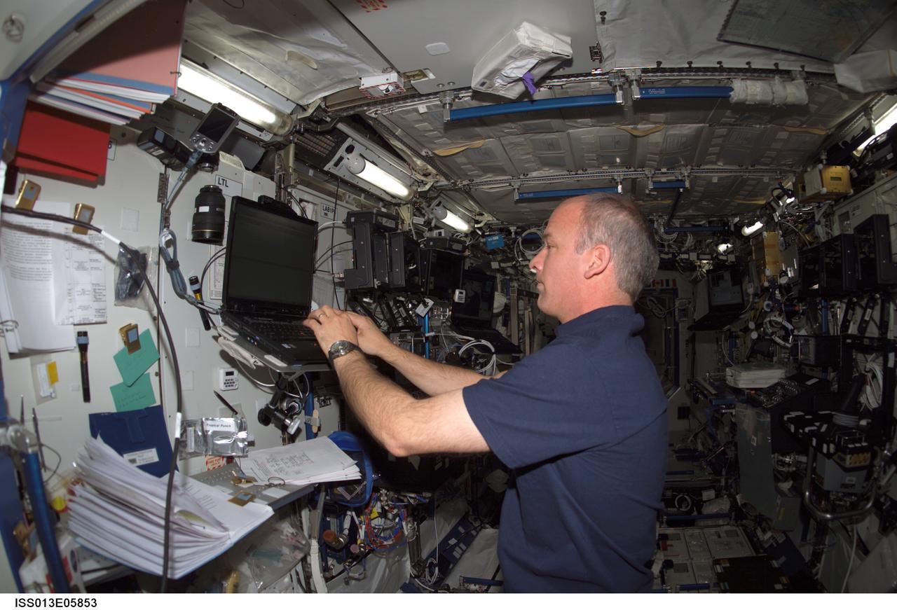 ISS013-E-05853 (11 April 2006) --- Astronaut Jeffrey N. Williams, Expedition 13 NASA space station science officer and flight engineer, uses a computer in the Destiny laboratory of the International Space Station.