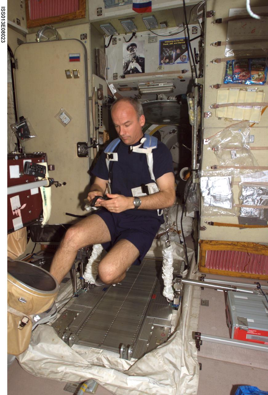 ISS013-E-08023 (18 April 2006) --- Astronaut Jeffrey N. Williams, Expedition 13 NASA space station science officer and flight engineer, prepares to exercise on the Treadmill Vibration Isolation System (TVIS) in the Zvezda Service Module of the International Space Station.
