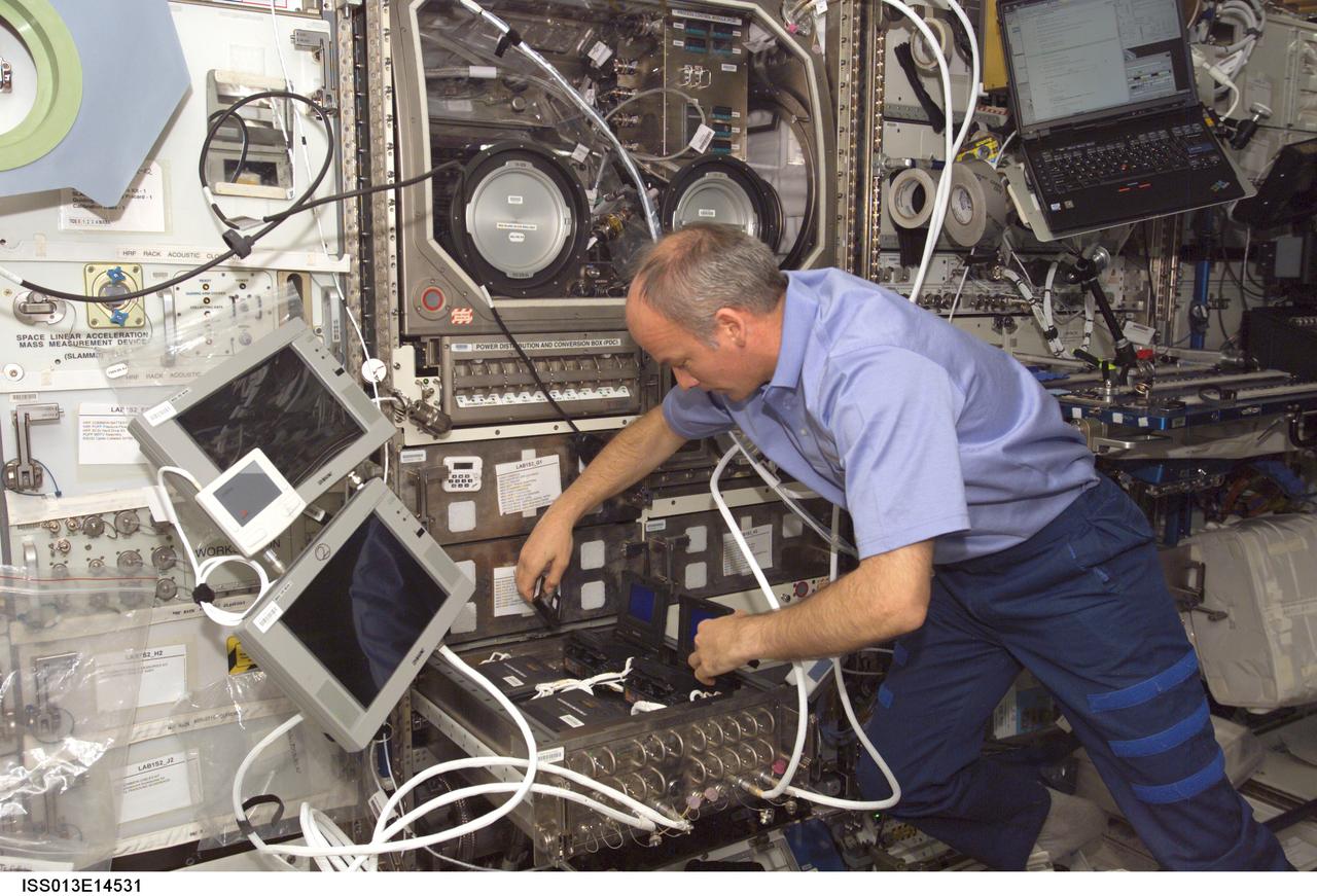 ISS013-E-14531 (4 May 2006) --- Astronaut Jeffrey N. Williams, Expedition 13 NASA space station science officer and flight engineer, conducts the first run of the Pore Formation and Mobility Investigation (PFMI) in the Microgravity Science Glovebox (MSG) in the Destiny laboratory of the International Space Station.