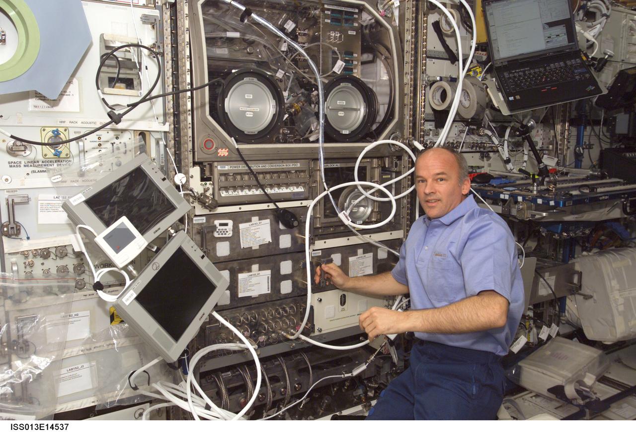 ISS013-E-14537 (4 May 2006) --- Astronaut Jeffrey N. Williams, Expedition 13 NASA space station science officer and flight engineer, conducts the first run of the Pore Formation and Mobility Investigation (PFMI) in the Microgravity Science Glovebox (MSG) in the Destiny laboratory of the International Space Station.