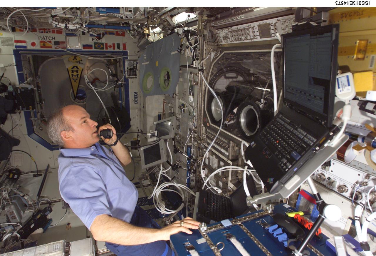 ISS013-E-14573 (4 May 2006) --- Astronaut Jeffrey N. Williams, Expedition 13 NASA space station science officer and flight engineer, conducts the first run of the Pore Formation and Mobility Investigation (PFMI) in the Microgravity Science Glovebox (MSG) in the Destiny laboratory of the International Space Station.