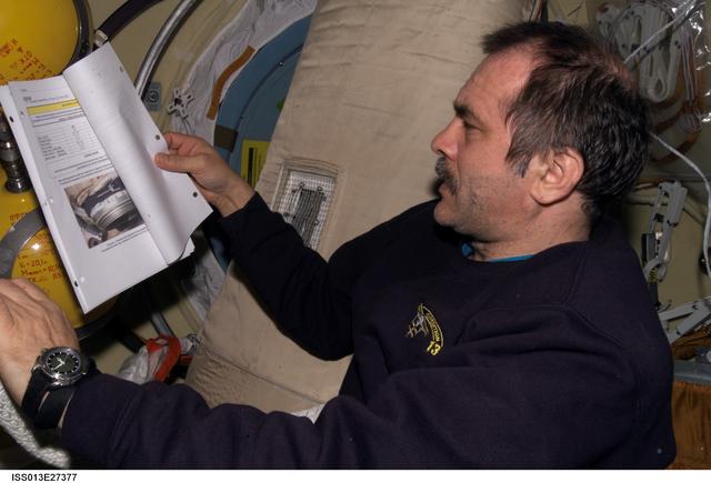NASA image: Vinogradov reads manual in the SM during Expedition 13