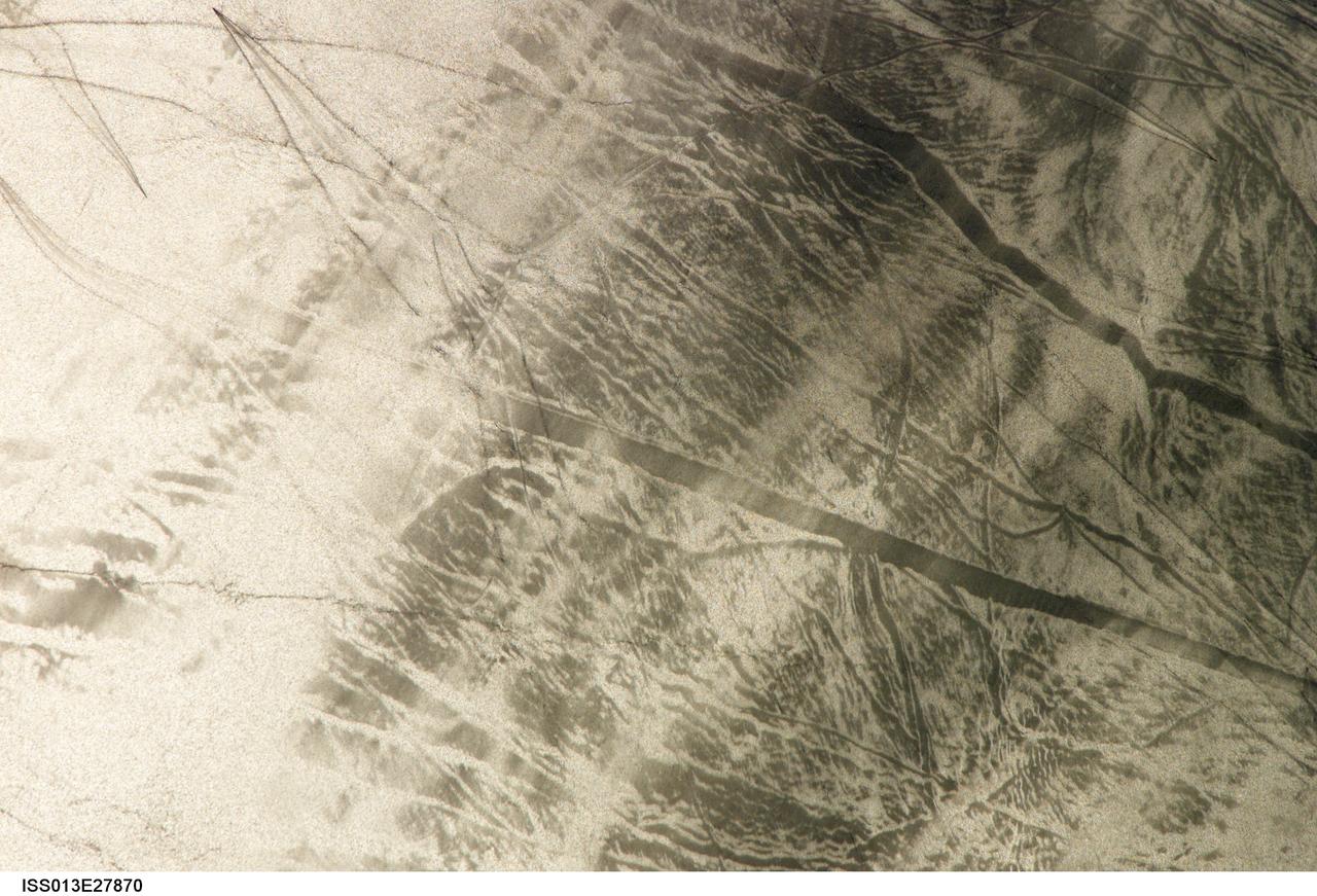 ISS013-E-27870 (28 May 2006) --- Considerable sunglint emphasizes features on Lake Erie in this image photographed by an Expedition 13 crewmember on the International Space Station. This detailed, south-looking image shows features on the surface of Lake Erie, about 30 miles west of Cleveland, Ohio. This view shows tight-V-shaped wakes of small craft. It also shows broad patterns of larger craft, probably large freighters carrying cargo that displace and disturb more water during passage. These larger wakes are aligned with the direct course between Detroit (out of frame) and Cleveland (out of frame). Some of the broad, ill-defined swaths of light and dark are streaks of wind-roughened water, which reflect the Sun differently.