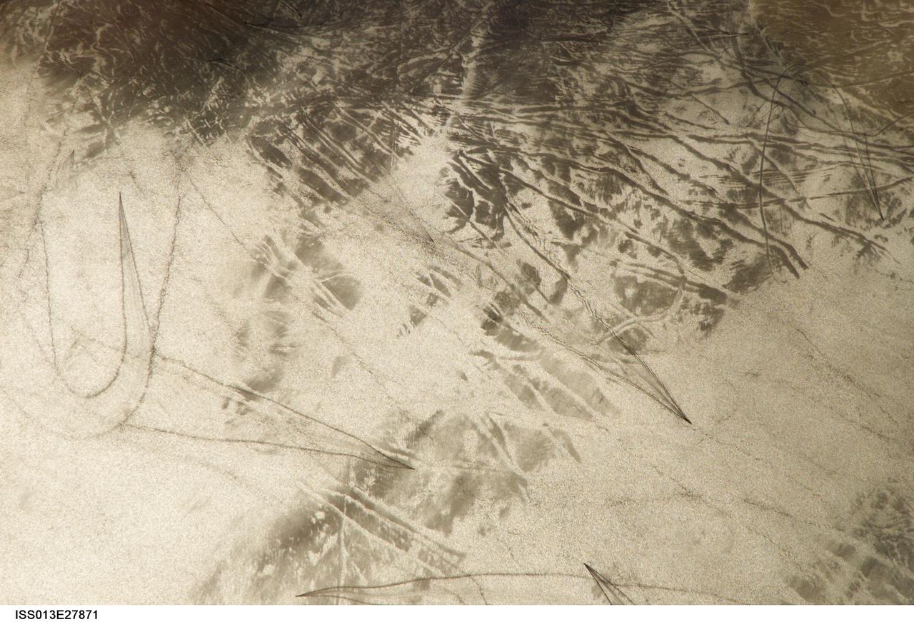 ISS013-E-27871 (28 May 2006) --- Considerable sunglint emphasizes features on Lake Erie in this image photographed by an Expedition 13 crewmember on the International Space Station. This detailed, south-looking image shows features on the surface of Lake Erie, about 30 miles west of Cleveland, Ohio. At left, a thin, V-shaped wake curves back towards the shore. This type of wake is typically created by a small, light craft such as a speedboat or sailboat under power.