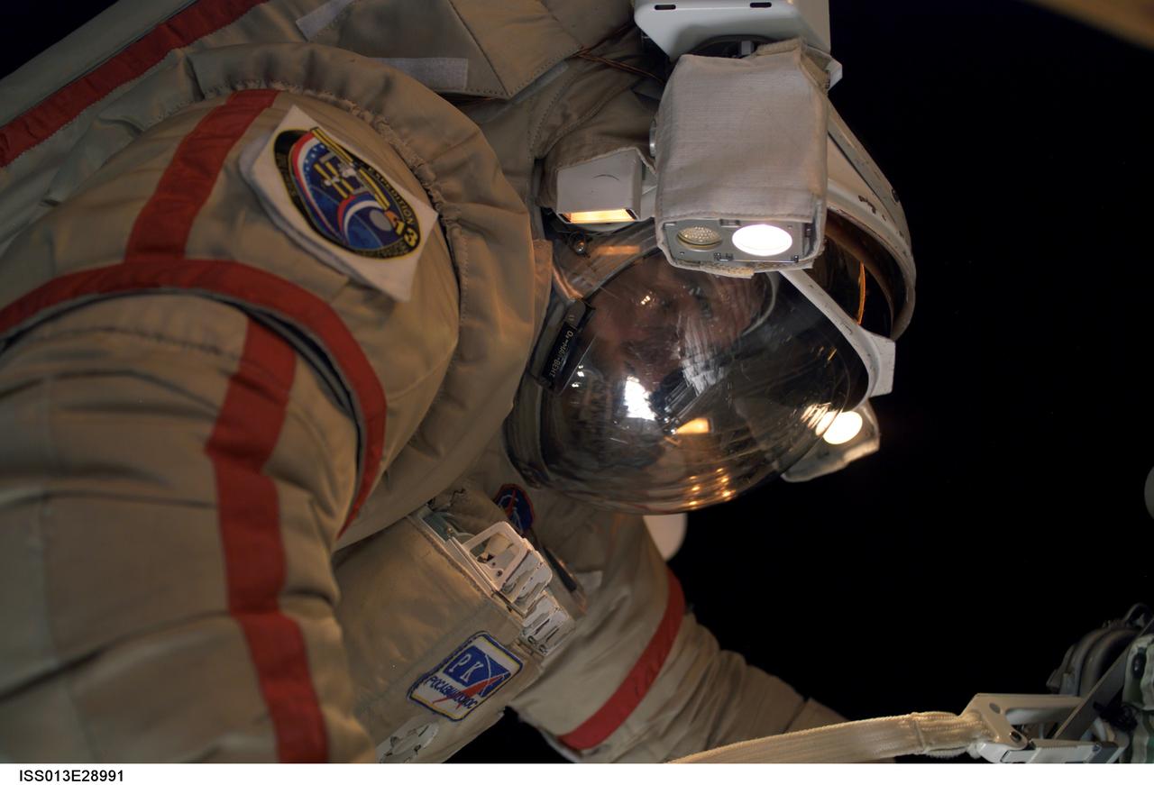 ISS013-E-28991 (1 June 2006) --- Cosmonaut Pavel V. Vinogradov, Expedition 13 commander representing Russia's Federal Space Agency, attired in a Russian Orlan spacesuit, participates in the first session of extravehicular activity (EVA) performed by the Expedition 13 crew during their six-month mission. During the 6-hour, 31-minute spacewalk, Vinogradov and astronaut Jeffrey N. Williams (out of frame), NASA space station science officer and flight engineer, repaired, retrieved and replaced hardware on the U.S. and Russian segments of the International Space Station.