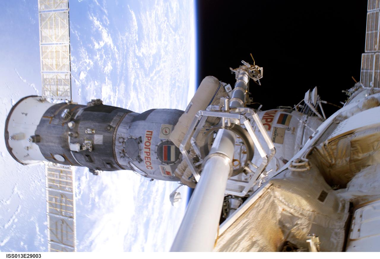 ISS013-E-29003 (1 June 2006) --- The Progress 20 supply vehicle, docked to the Pirs Docking Compartment of the International Space Station, is featured in this image photographed by an Expedition 13 crewmember during today’s spacewalk. Progress 20 will remain docked until mid-June. It will be used to stow trash, and its supply of oxygen will help replenish the station’s atmosphere. A blue and white Earth and the blackness of space provided the backdrop for this image.