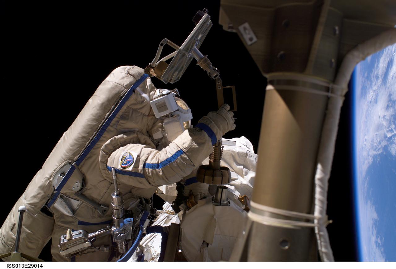 ISS013-E-29014 (1 June 2006) --- Astronaut Jeffrey N. Williams, Expedition 13 NASA space station science officer and flight engineer, attired in a Russian Orlan spacesuit, participates in the first session of extravehicular activity (EVA) performed by the Expedition 13 crew during their six-month mission. During the 6-hour, 31-minute spacewalk, Williams and cosmonaut Pavel V. Vinogradov (out of frame), commander representing Russia's Federal Space Agency, repaired, retrieved and replaced hardware on the U.S. and Russian segments of the International Space Station.