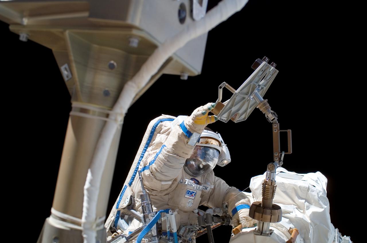 ISS013-E-29017 (1 June 2006) --- Astronaut Jeffrey N. Williams, Expedition 13 NASA space station science officer and flight engineer, attired in a Russian Orlan spacesuit, participates in the first session of extravehicular activity (EVA) performed by the Expedition 13 crew during their six-month mission. During the 6-hour, 31-minute spacewalk, Williams and cosmonaut Pavel V. Vinogradov (out of frame), commander representing Russia's Federal Space Agency, repaired, retrieved and replaced hardware on the U.S. and Russian segments of the International Space Station.