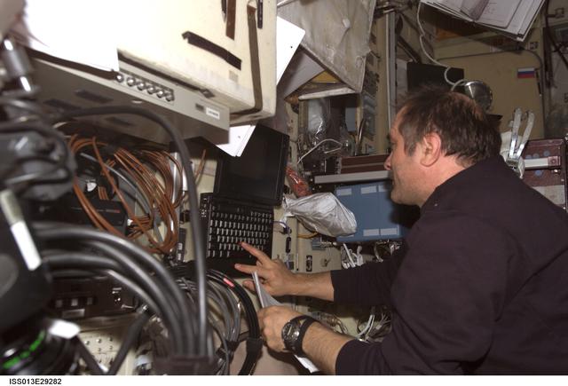 NASA image: Vinogradov enters data into laptop computer in the SM during Expedition 13
