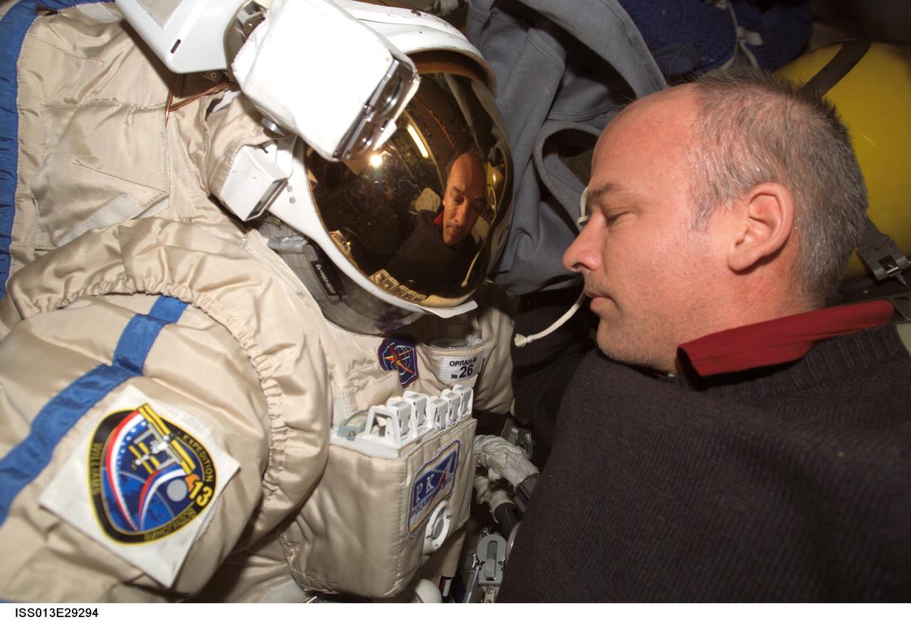 ISS013-E-29294 (1 June 2006) --- Astronaut Jeffrey N. Williams, Expedition 13 NASA space station science officer and flight engineer, checks out his Russian Orlan spacesuit in the Pirs Docking Compartment of the International Space Station prior to today&#0146;s session of extravehicular activity (EVA).