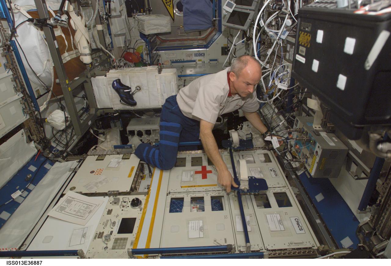 ISS013-E-36887 (13 June 2006) --- Astronaut Jeffrey N. Williams, Expedition 13 NASA space station science officer and flight engineer, deactivates the Crew Health Care System (CHeCS) rack in the Destiny laboratory of the International Space Station.