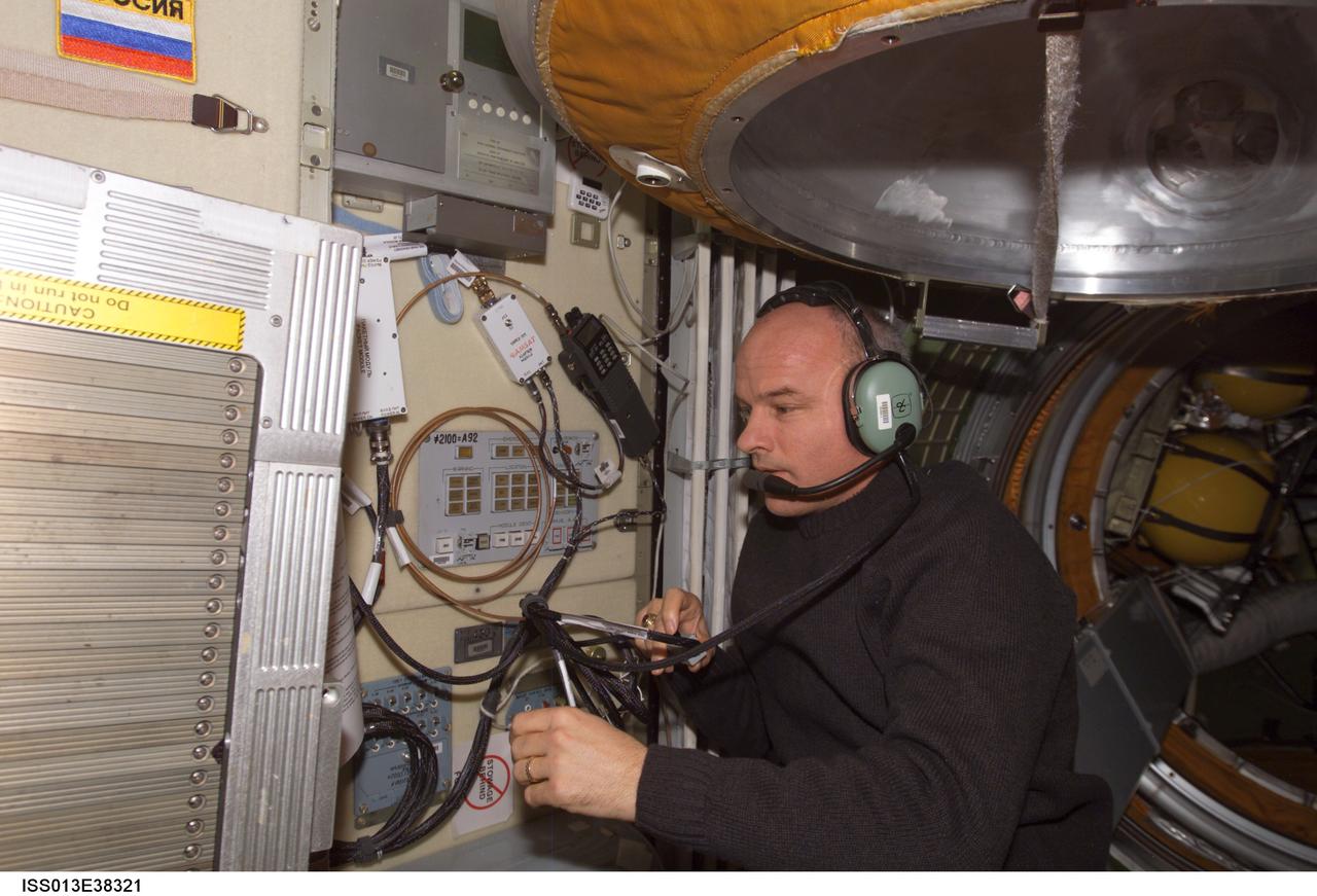 ISS013-E-38321 (17 June 2006) --- Astronaut Jeffrey N. Williams, Expedition 13 NASA space station science officer and flight engineer, uses the amateur radio system in the Zarya functional cargo block (FGB) to talk with school children during an Amateur Radio on the International Space Station (ARISS) contact. Two amateur radio stations are currently installed on the station.