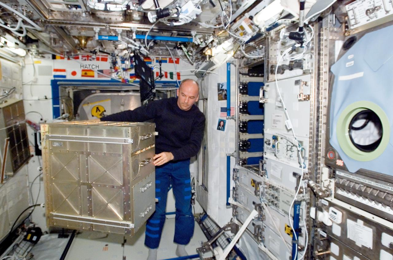 ISS013-E-38339 (17 June 2006) --- Astronaut Jeffrey N. Williams, Expedition 13 NASA space station science officer and flight engineer, works with a section of the Human Research Facility (HRF) rack in the Destiny laboratory of the International Space Station.