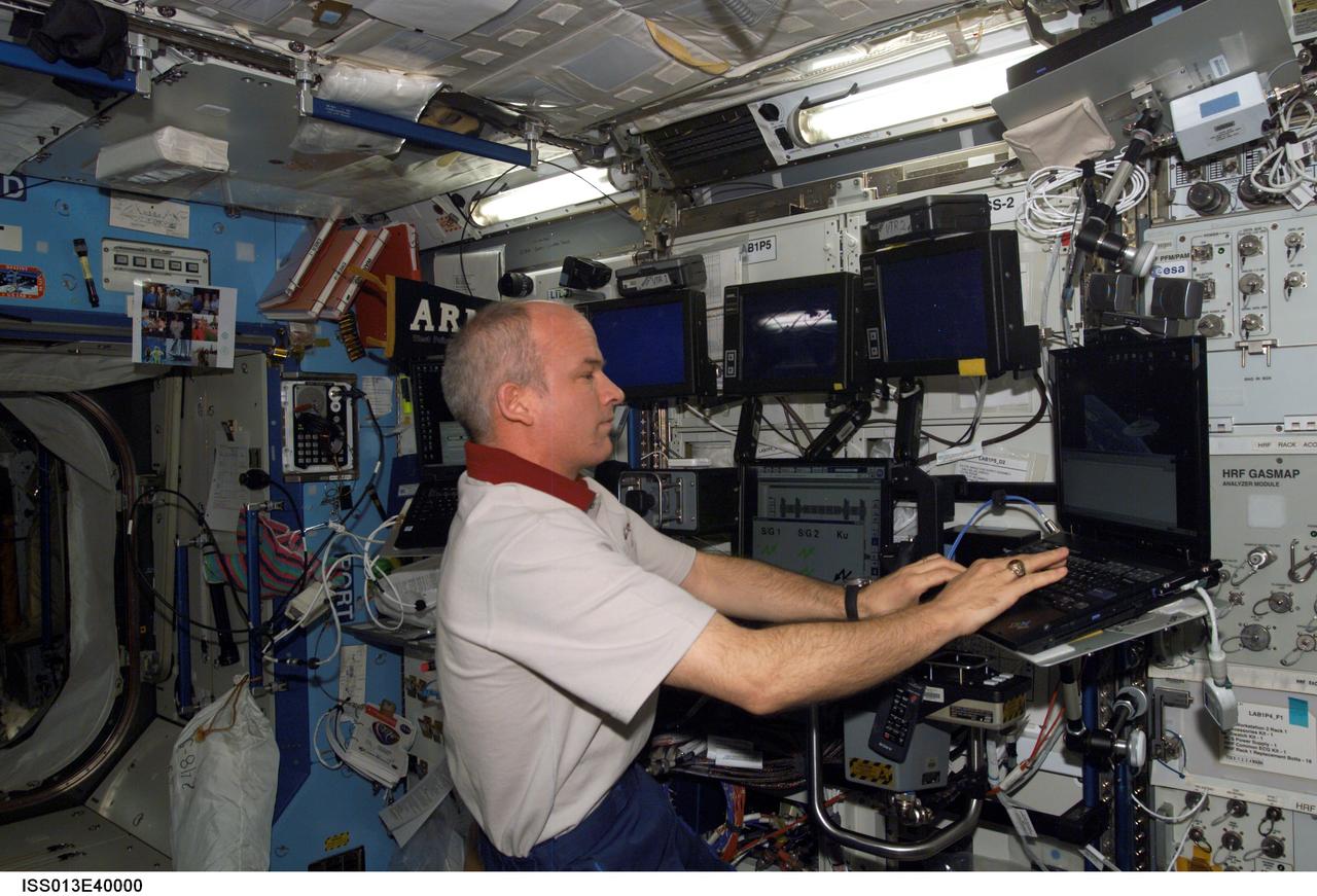 ISS013-E-40000 (22 June 2006) --- Astronaut Jeffrey N. Williams, Expedition 13 NASA space station science officer and flight engineer, uses a computer in the Destiny laboratory of the International Space Station.