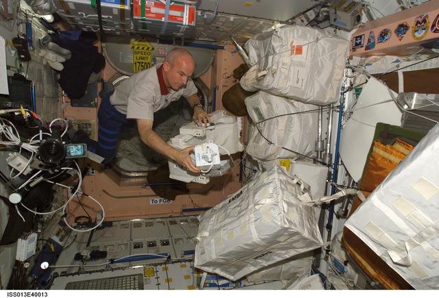 NASA image: Williams works with stowage containers in the Node 1 during Expedition 13