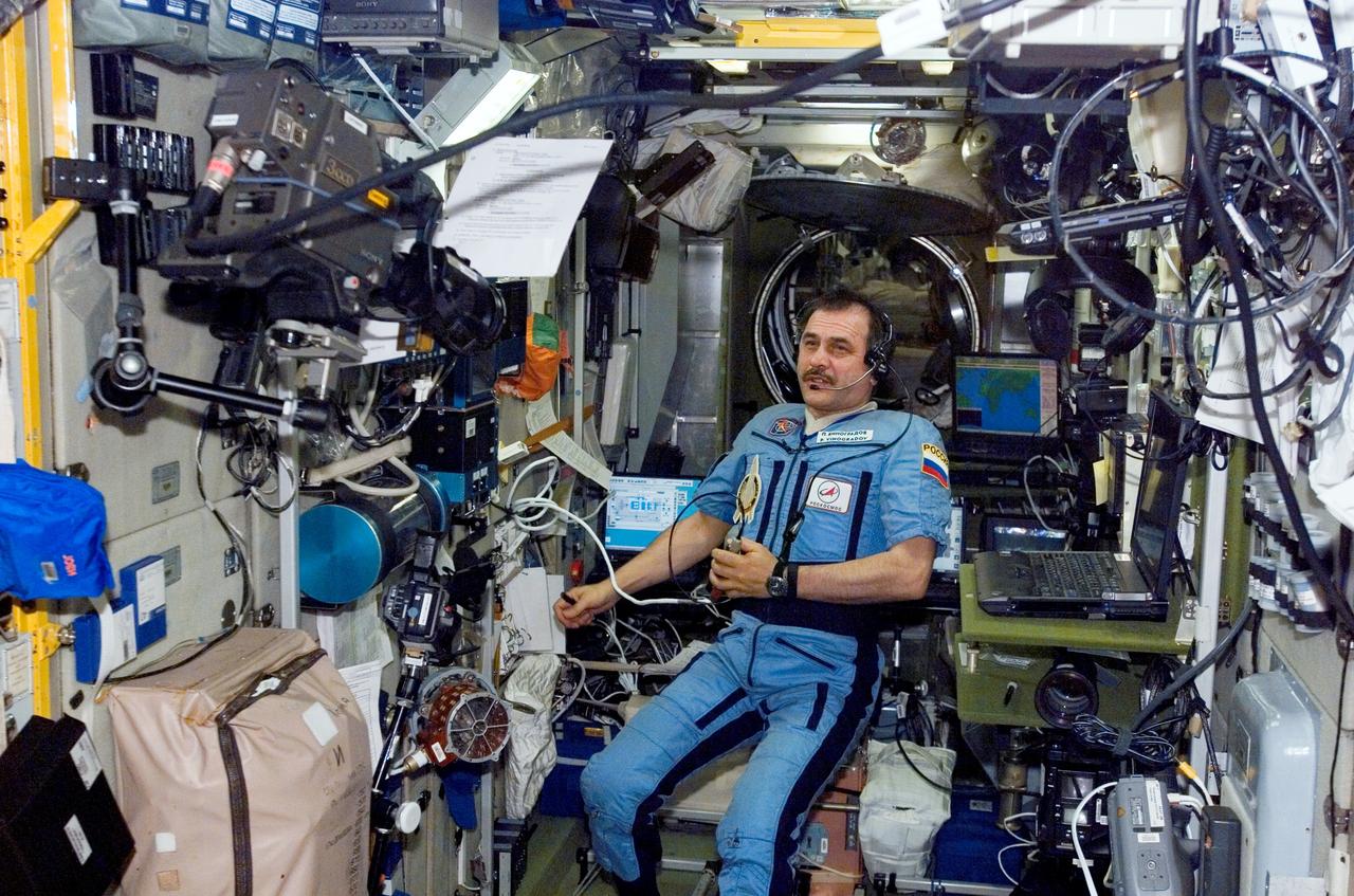 ISS013-E-40015 (22 June 2006) --- Cosmonaut Pavel V. Vinogradov, Expedition 13 commander representing Russia's Federal Space Agency, uses a communication system in the Zvezda Service Module of the International Space Station.