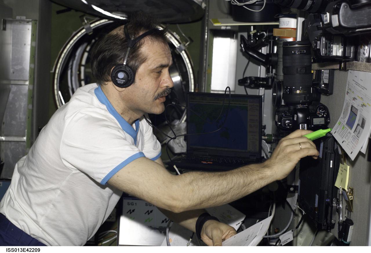 ISS013-E-42209 (26 June 2006) --- Cosmonaut Pavel V. Vinogradov, Expedition 13 commander representing Russia's Federal Space Agency, practices docking procedures with the TORU teleoperated control system in the Zvezda Service Module of the International Space Station in preparation for the docking of the Progress 22 spacecraft. Vinogradov, using the Simvol-TS screen and hand controllers, could manually dock the Progress to the station in the event of a failure of the Kurs automated docking system.