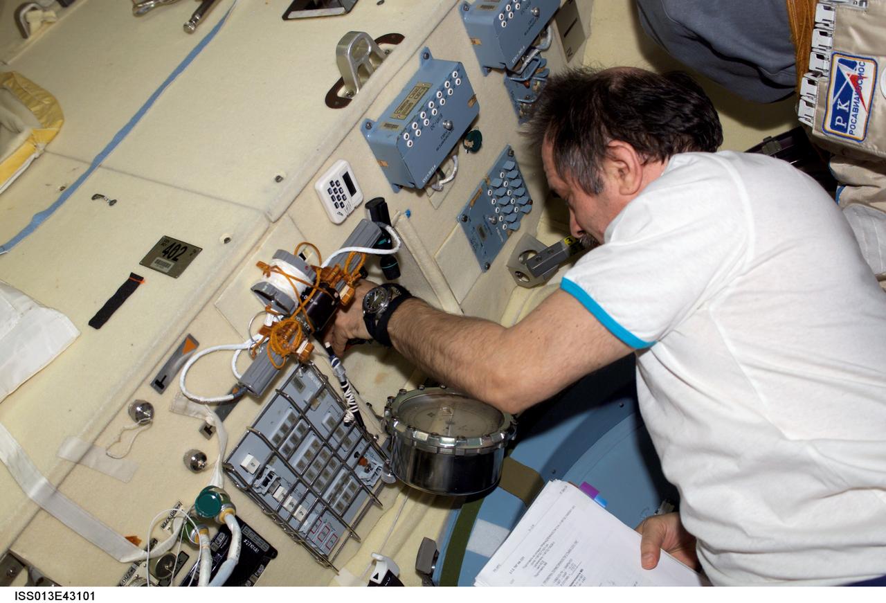 ISS013-E-43101 (26 June 2006) --- Cosmonaut Pavel V. Vinogradov, Expedition 13 commander representing Russia's Federal Space Agency, works on a panel in the Pirs Docking Compartment of the International Space Station.
