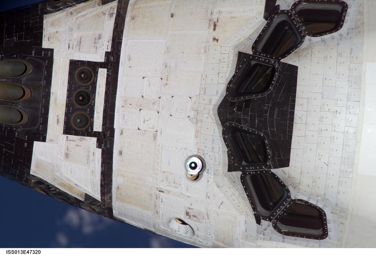 ISS013E47320 (06 July 2006) -- View of the Orbiter Discovery topside of the forward (FWD) flight deck as imaged during the mapping sequence performed by Expedition 13 NASA Space Station crew during STS-121 R-Bar Pitch Maneuver on Flight Day 3. This image was taken with the 800mm lens prior to rendezvous and docking operations.
