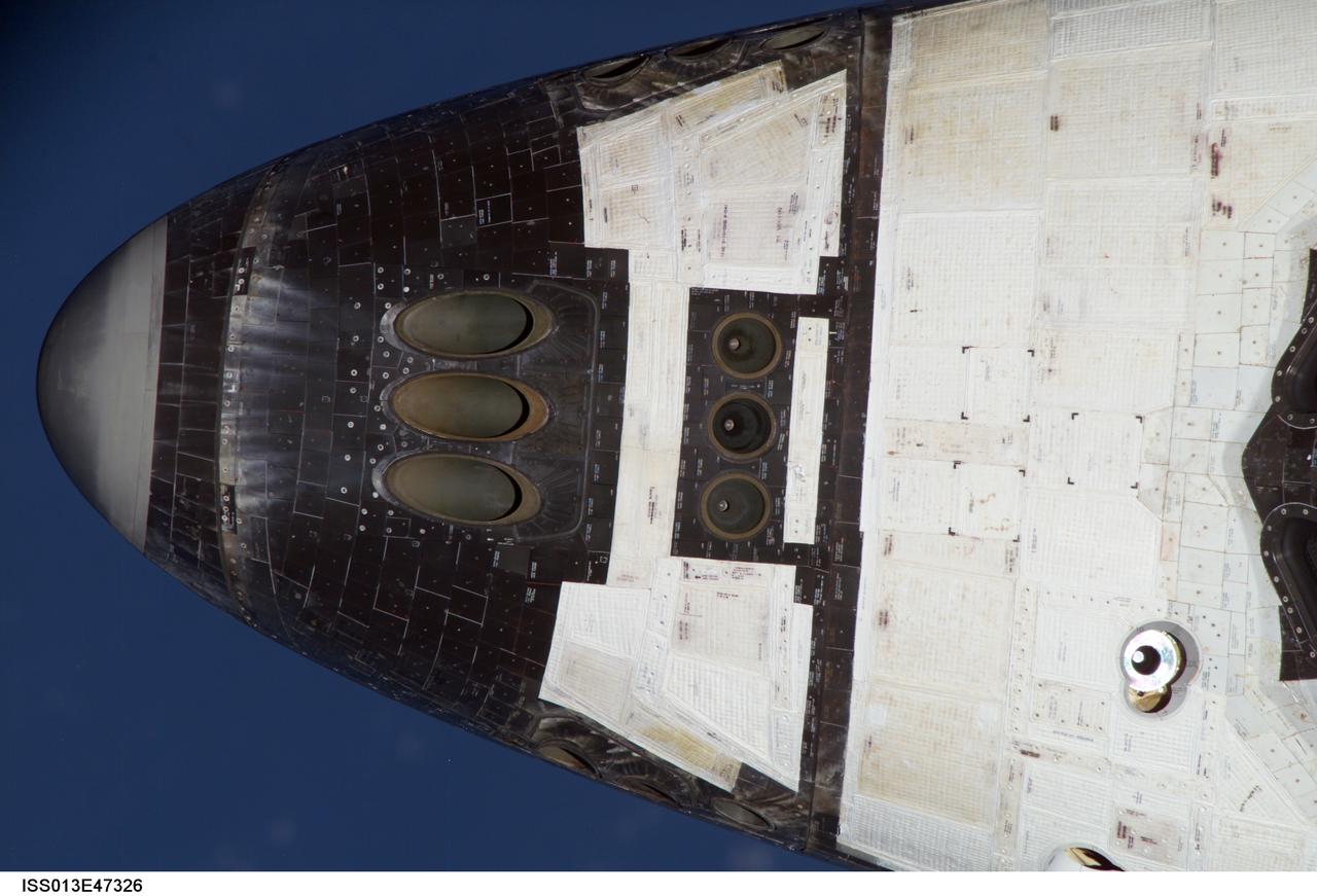 ISS013E47326 (06 July 2006) -- View of the Orbiter Discovery nosecap as imaged during the mapping sequence performed by Expedition 13 NASA Space Station crew during STS-121 R-Bar Pitch Maneuver on Flight Day 3. This image was taken with the 800mm lens prior to rendezvous and docking operations.