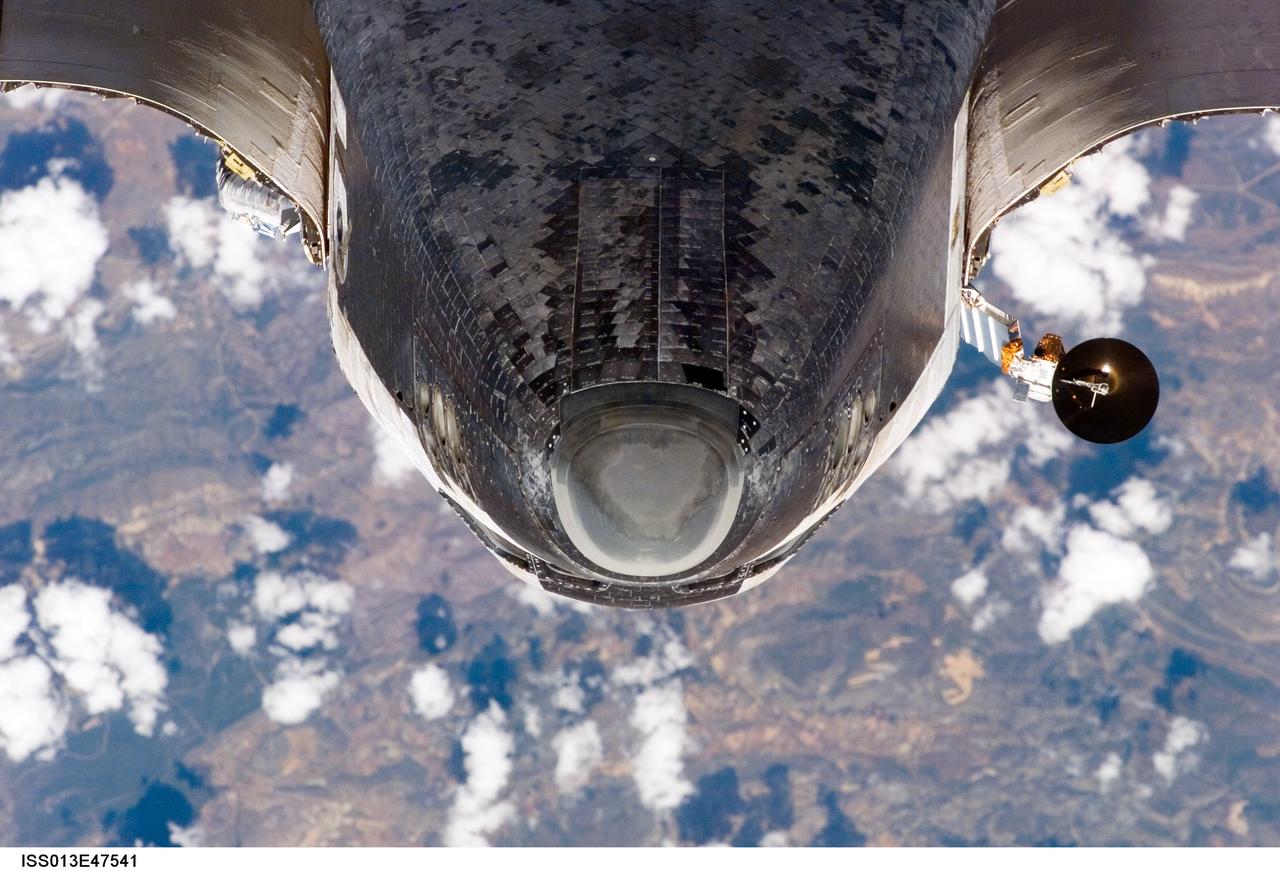 ISS013-E-47541 (6 July 2006) --- The nose of Shuttle Discovery and part of the forward underside as photographed by one of the Expedition 13 crewmembers from the International Space Station on July 6 during RPM survey.