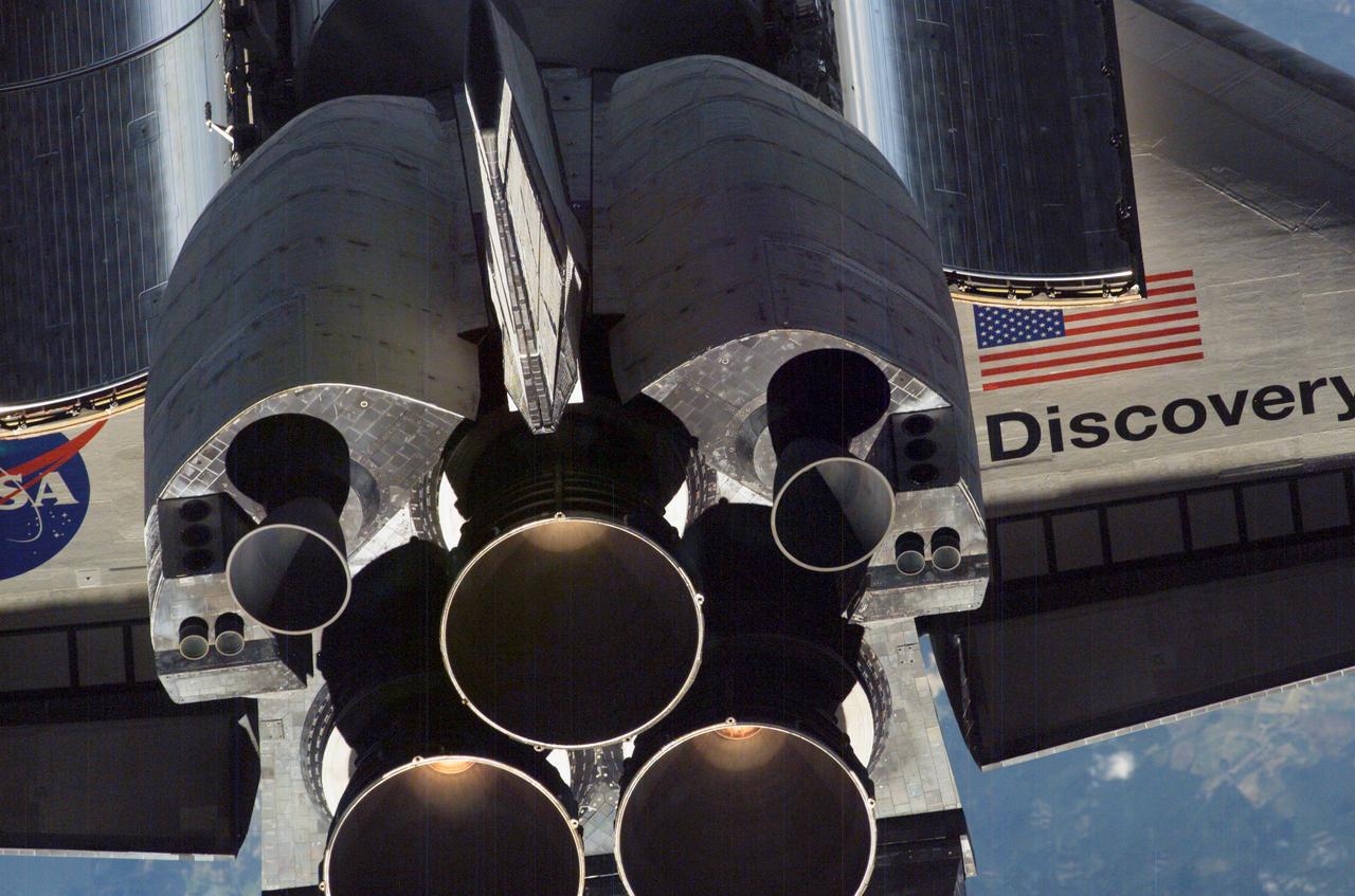 ISS013-E-47643 (6 July 2006) --- A close-up view of Space Shuttle Discovery's tail section is featured in this image photographed by an Expedition 13 crewmember on the International Space Station during RPM survey. Visible are the shuttle's main engines, vertical stabilizer, orbital maneuvering system (OMS) pods and a portion of the aft cargo bay and wings.